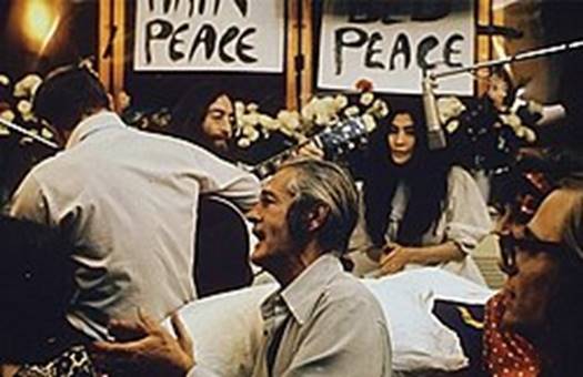 https://upload.wikimedia.org/wikipedia/commons/thumb/2/24/John_Lennon_performing_Give_Peace_a_Chance_1969.jpg/250px-John_Lennon_performing_Give_Peace_a_Chance_1969.jpg